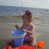 Infant playing with buckets Buckets to use for swimming lessons