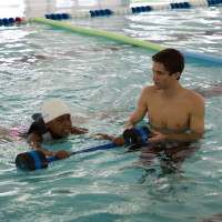 Barbell Advanced Hold - Head out of water Child holding barbell in Advanced position. Should be Head in the water.